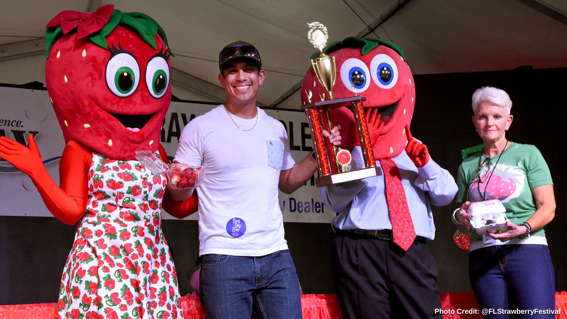 Berry Fest 23 on stage winner with trophy and mr. and mrs. berry